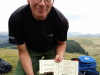Day 7 - Trailside repair novelty ... having run out of tyre boots improvising On slopes of Cefn y Ystrad with laminated menu after Paul`s tyre splits again! © Paul Bonwick