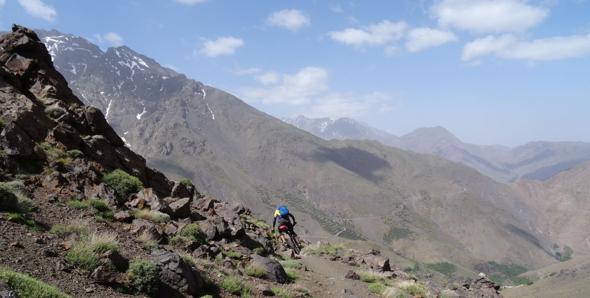 Day 8 - Awww, don`t take a photo when I`m briefly feet-down trying to thread through rocks so I don`t snap off my rear derailleur again! Descent from Tizi-n-Eddi to the village of Tizi-n-Tacheddirt. Jbel Aksoual (12,828 ft) is on the far left, on the horizon © Steve Woodward