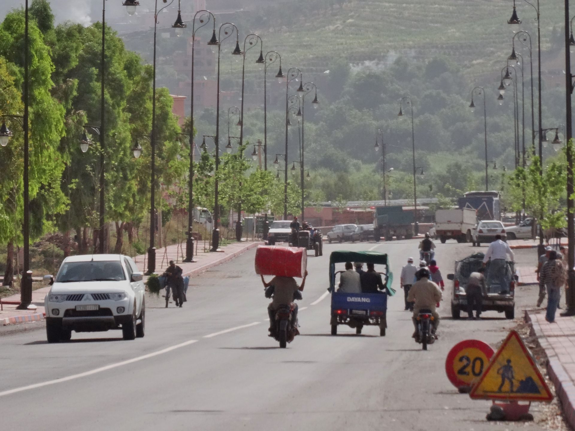 Day 9 - On the road to Marrakesh: improvised "roof rack" to carry the red oil drum on the motorbike ... ! © Steve Woodward