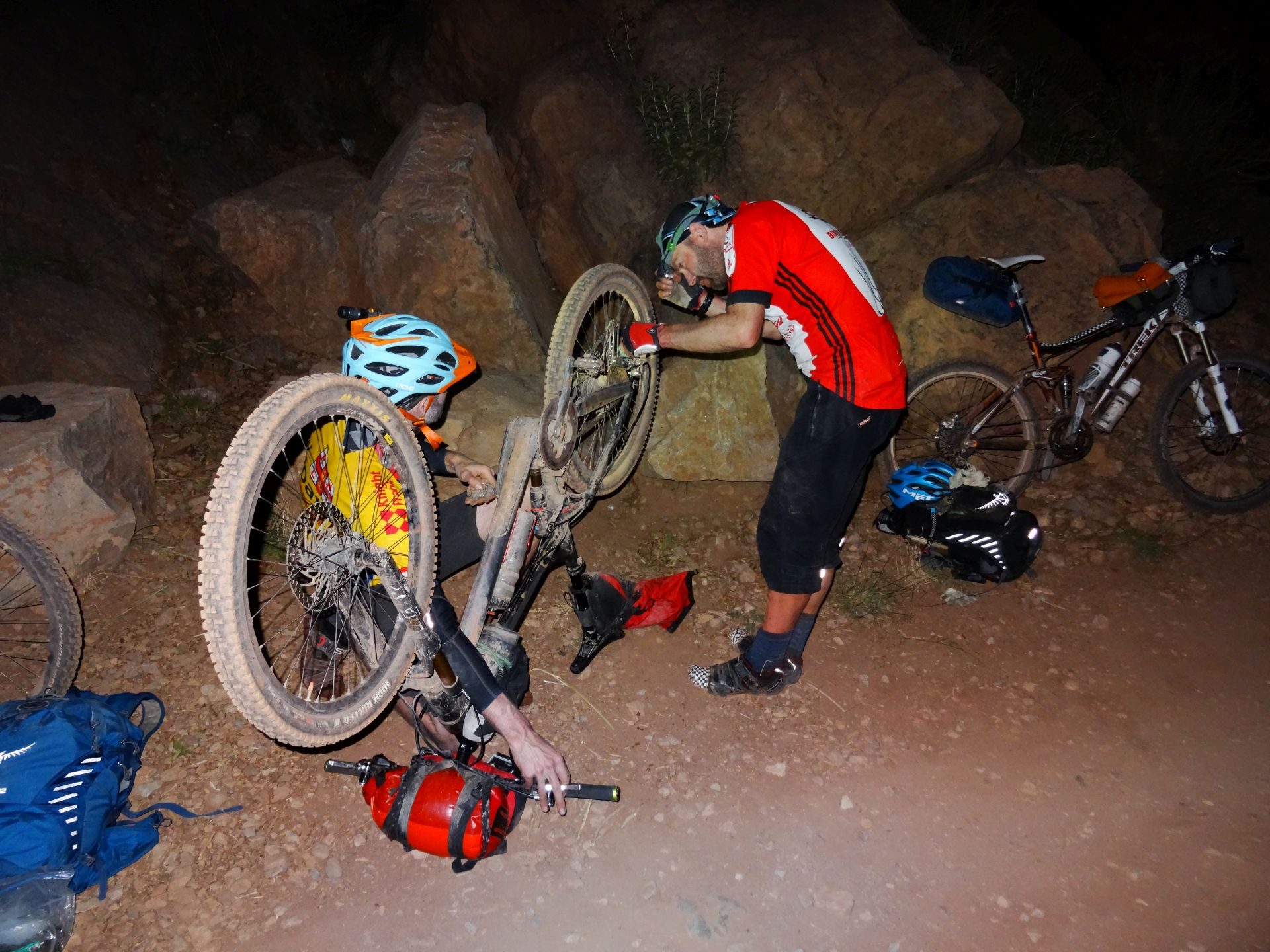 Day 6 - Repairing a snapped-off rear derailleur in the dark, after nearly 14 hours on the bikes. "Can we fix it? ... Yes we can!". Shaun AKA Bob the Builder master-mechanic does the final checks ... Somewhere between Tighza & Anguelz! © Steve Woodward
