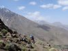 Day 8 - Awww, don`t take a photo when I`m briefly feet-down trying to thread through rocks so I don`t snap off my rear derailleur again! Descent from Tizi-n-Eddi to the village of Tizi-n-Tacheddirt. Jbel Aksoual (12,828 ft) is on the far left, on the horizon © Steve Woodward
