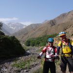 Day 9 - It`s been a long two weeks on the road! We`re on our bikes right? Right? ;) "Riding" beside the Oued Rheraya river, on the way back to Marrakesh. The mountain on the left is the highest peak in North Africa, Jbel Toubkal (13,671 ft). Crikey. © Steve Woodward