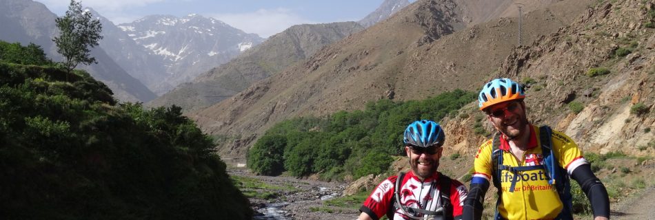 Day 9 - It`s been a long two weeks on the road! We`re on our bikes right? Right? ;) "Riding" beside the Oued Rheraya river, on the way back to Marrakesh. The mountain on the left is the highest peak in North Africa, Jbel Toubkal (13,671 ft). Crikey. © Steve Woodward