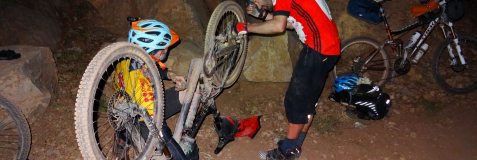 Day 6 - Repairing a snapped-off rear derailleur in the dark, after nearly 14 hours on the bikes. "Can we fix it? ... Yes we can!". Shaun AKA Bob the Builder master-mechanic does the final checks ... Somewhere between Tighza & Anguelz! © Steve Woodward